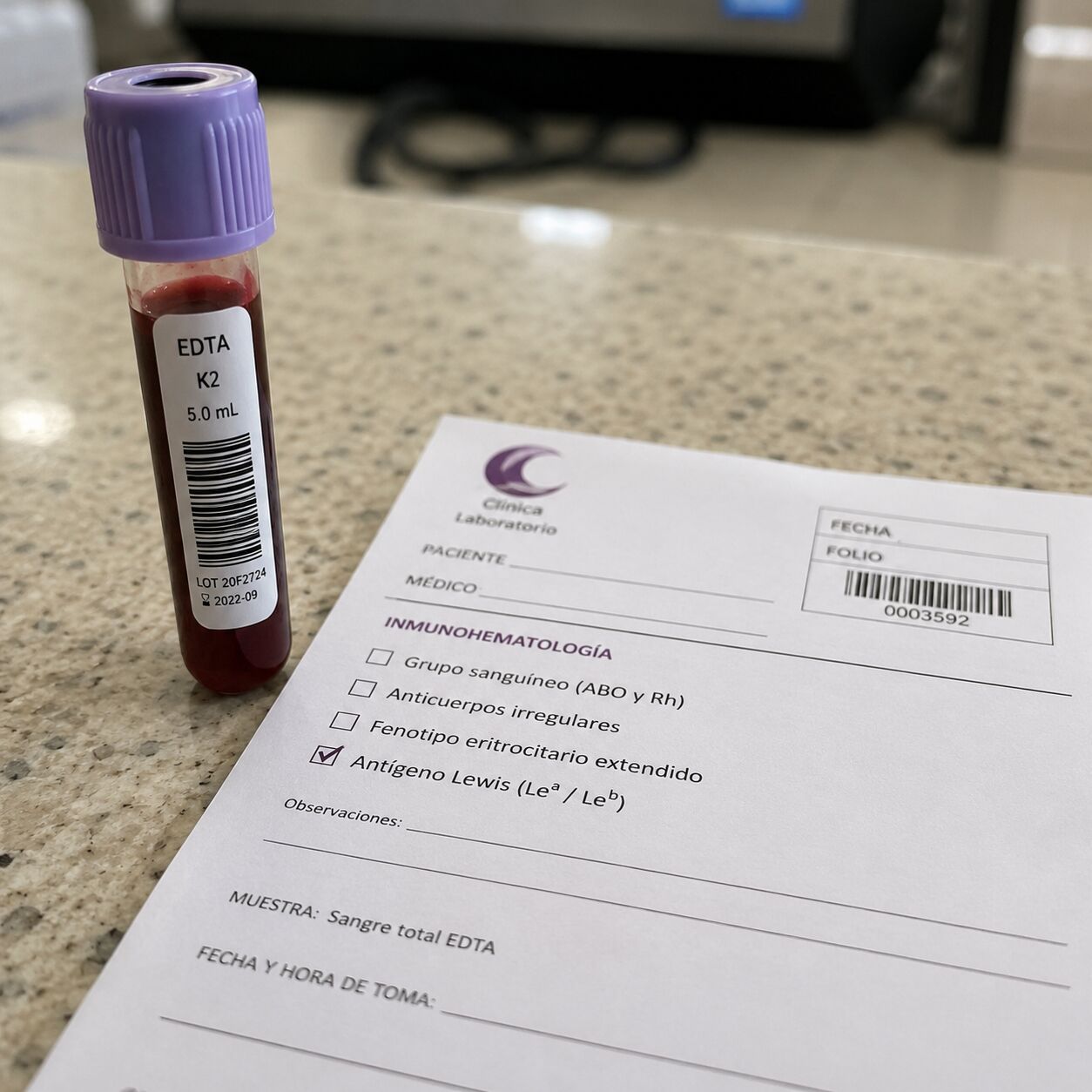 A small blood sample vial beside a lab requisition slip labeled for Lewis antigen blood group testing