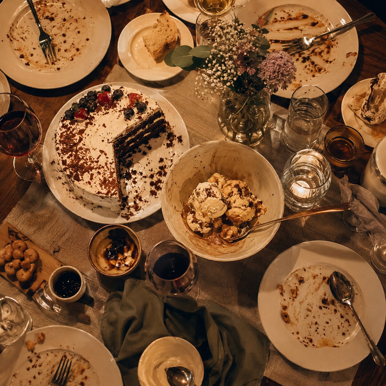 Table setting with a large, sugar-rich meal and dessert, representing a temporary post-meal glucose spike that can briefly exceed the kidney's reabsorption capacity